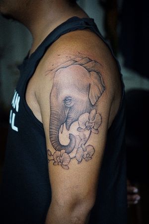 𝙄𝙂: 𝙣𝙖𝙩𝙚_𝙩𝙝𝙖𝙞𝙡𝙖𝙣𝙙 🍃 Realistic blackwork Thai elephant tattoo with orchid flowers by Baan Khagee Tattoo Chiang Mai, Thailand at Baan Khagee Tattoo in Chiang Mai