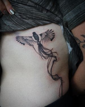 𝙄𝙂: 𝙣𝙖𝙩𝙚_𝙩𝙝𝙖𝙞𝙡𝙖𝙣𝙙 🍃 Flying Magpie bird tattoo with flowing tail done by a Thai tattoo artist in Chiang Mai, Thailand at Baan Khagee Tattoo in Chiang Mai