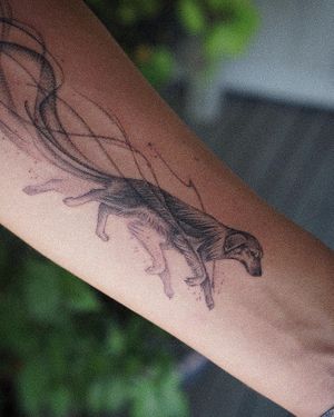 𝙄𝙂: 𝙣𝙖𝙩𝙚_𝙩𝙝𝙖𝙞𝙡𝙖𝙣𝙙 🍃 Realistic dog tattoo with flowing tail on forearm by Baan Khagee Tattoo Chiang Mai, Thailand at Baan Khagee Tattoo in Chiang Mai