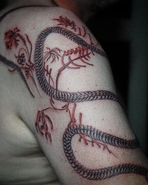 𝙄𝙂: 𝙣𝙖𝙩𝙚_𝙩𝙝𝙖𝙞𝙡𝙖𝙣𝙙 🍃 Fine line snake skeleton tattoo with dying flower by Baan Khagee Tattoo Chiang Mai, Thailand at Baan Khagee Tattoo in Chiang Mai