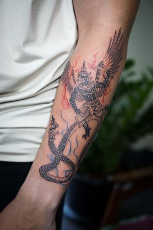 𝙄𝙂: 𝙣𝙖𝙩𝙚_𝙩𝙝𝙖𝙞𝙡𝙖𝙣𝙙 🍃 Blackwork Thai Krut and Naga tattoo in fighting scene by a Thai tattooist in Chiang Mai, Thailand  at Baan Khagee Tattoo in Chiang Mai
