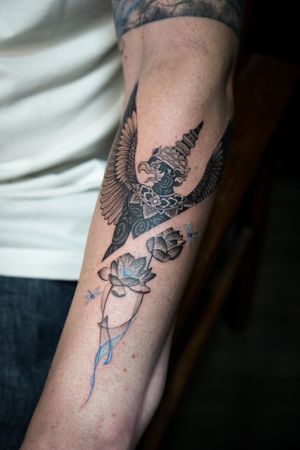 𝙄𝙂: 𝙣𝙖𝙩𝙚_𝙩𝙝𝙖𝙞𝙡𝙖𝙣𝙙 🍃 Blackwork Thai Krut with lotus flowers tattoo on the forearm by a Thai tattooist in Chiang Mai, Thailand at Baan Khagee Tattoo in Chiang Mai