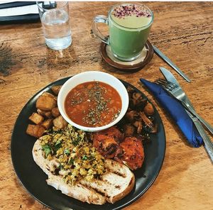 Delicious full vegan breakfast with a matcha and ginger latte made with coconut milk.  at The Chakra Lounge in Buxton