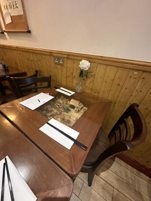 Miniature villages under the glass top tables   at Sen Viet Vegan in East London