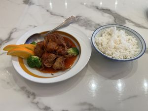 Honey tangerine chicken served with a side of white rice  at Mamak Vegan Kitchen in Chamblee