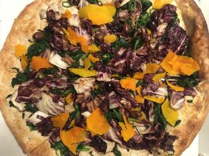 Uno whole wheat pizza, topped with red chicory, spinach, pumpkin, and olives  at Nonsolopizza in Cremona