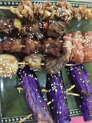 BBQ skewers - skewered yuba, two types of seitan, trumpet mushroom caps, eggplant and enoki mushroom wrapped inside smoky veggie ham  at Míng Xiāng Yuán 名湘園蔬食燒烤 in Tainan