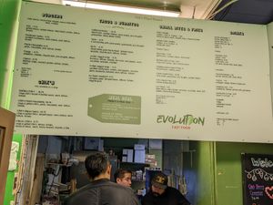 Indoor menu board at Evolution Fast Food in San Diego