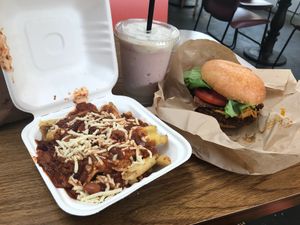 Bacon cheeseburger with chili’s cheese fries and a shake at Evolution Fast Food in San Diego