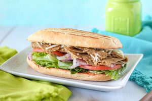 Vegan Patch Sub: organic romaine, tomato, onions, salt & pepper, olive oil & red wine vinegar, seitan deli slices, vegan mozzarella cheese, homemade vegan ranch on a Cuban roll. at Nature's Food Patch Market & Café in Dunedin