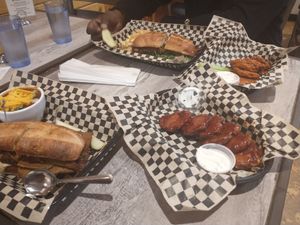 A feast! Wings, chili, Steak Bomb and Madison Philly sandwiches at The Green Owl Cafe in Madison