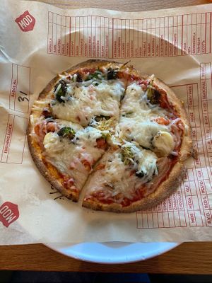 Vegan cheese with roasted broccoli, spinach, and diced tomatoes. A few roasted garlic just to try.  at Mod Pizza in Lutz