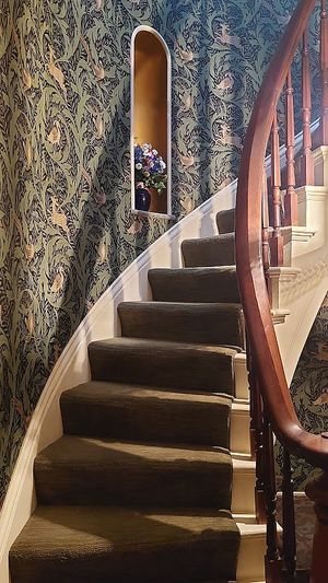 Staircase behind front door. William Morris wallpaper at Black Sheep Inn in Hammondsport