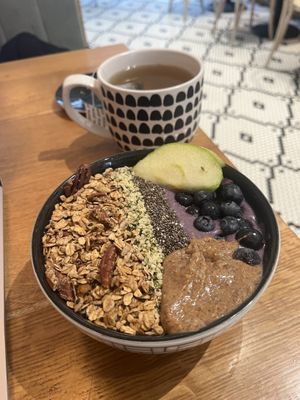 Blueberry smoothie bowl with almond butter and a Ctrl/alt/delete tea. 😋   at Kupfert & Kim - Yonge-Eg in Toronto
