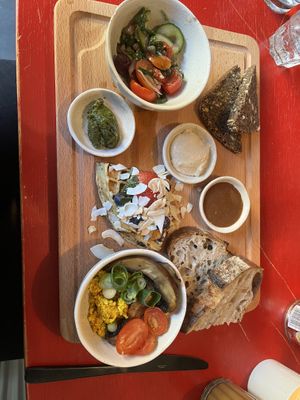 Scrambled tofu, greek salad, hummus, pesto & waffle with homemade vegan nutella, fruits & berries. Rye- & sourdough bread.                   Waffle was too dry for me.   at Flavour Bastards in Copenhagen