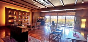Hotel lobby, with Kumamon sitting on a chair looking outside. at Ryokan Ayunosato in Hitoyoshi