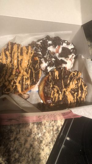 2 “Old Dirty Bastards Doughnut” , 1 “Dirt” Doughnut, & 1 “VooDoo Doll Doughnut (underneath)”  at Voodoo Doughnut - Washington Ave in Houston