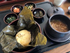A savory soybean soup with rice cooked in a lotus leaf - and banchan at Balwoo Gongyang - 발우공양 in Seoul