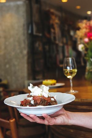 "Dakos" our traditional salad with organic olive oil, tomato, carob rusk and Mότher's homemade cheese from cashews! at Mother Vegan Bistro in Athens