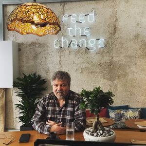 Basilis enjoys our bio coffee and classical music! at Mother Vegan Bistro in Athens