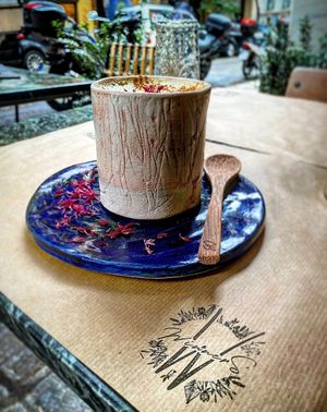 Turmeric latte with black pepper and medjool dates!! On top they have some micro rose petals bio that comes from mountain Olympus at Winners Vegan Restaurant in Athens