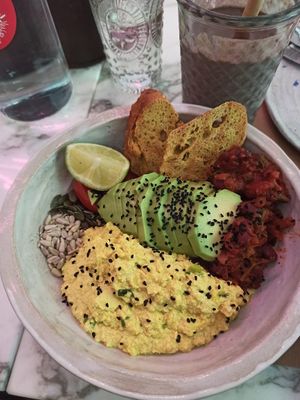 Winners breakfast! Scrambled tofu smokey beans avocado cherry tomatoes sourdough turmeric and chili bread omega seeds at Winners Vegan Restaurant in Athens