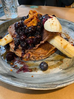Blueberry pancakes! Simply amazing! Ripe banana blueberry sauce with no sugar, bio all purpose flour and apple puree! Toped with “hony”comb at Winners Vegan Restaurant in Athens
