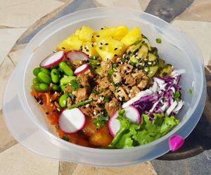 Poke bowl tofu in reusable container. at Matcha Café in Dakar