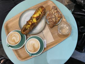 Oat cappuccinos, ‘hotdog’ sandwich and almond croissant   at Land & Monkeys - Beaumarchais in Paris