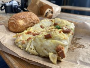 Focaccia with bacon, onion, cheese + Pain au Chocolat  at Land & Monkeys - Beaumarchais in Paris