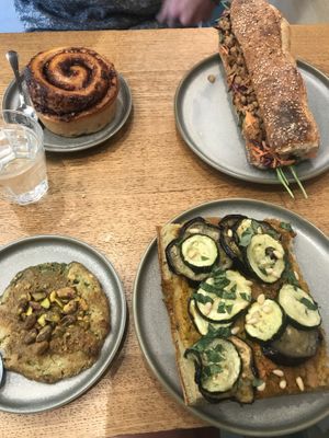 Focaccia, chicken sandwich, babka roll and chimp cookie (a must try for pistachio lovers!) - all delicious 😋  at Land & Monkeys - Beaumarchais in Paris