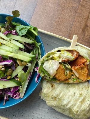 The chikin caesar wrap with a side of green salad at Vegan Street in Calgary