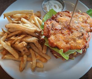 Nothin' but class burger, with a smashed plantain as a gluten free substitution, with garlic fries at Vegan Street in Calgary