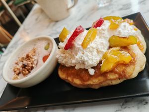 Brunch : Pancakes, apricot jam with rosemary, fresh fruit and whipped cream with banana granola. at Urban Greener in Paris
