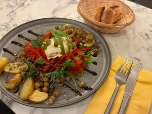 Homemade mozza, old tomatoes, candied red pepper, pesto, potatoes, and chickpea granola at Urban Greener in Paris
