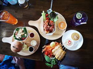 Bacon Burger with Cesar Salad, Cauliflower Wings, Date Tofu Salad, Lime Iced Tea, Butterfly Pea Iced Tea at Veganerie - Nana in Bangkok