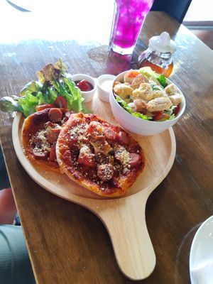 Double pizza at with Ceasar salad at Veganerie - Nana in Bangkok