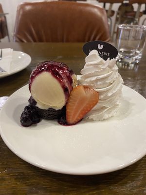 Flourless brownie with vanilla ice cream and coconut whipped cream   at Veganerie - Nana in Bangkok