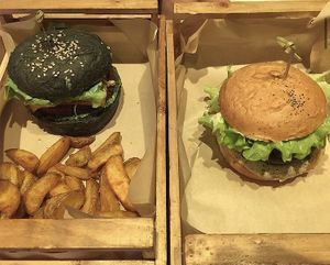 seitan with a charcoal bun and one with tofu and mushroom sauce at Flower Burger in Rome