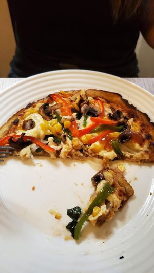 Personal sized pizza (half eaten) at Verdecelli  - Coco's Cafe in Cuenca