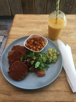 Wow another amazing heavenly divine meal, Zucchini Carrot Chickpea Fritters with smash avocado and Super Sea Moss Smoothie with coconut water, mango, pineapple, sea moss, banana at Vibes Cafe in South West London
