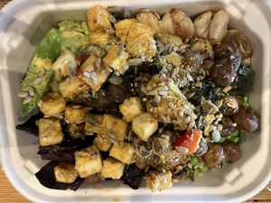 Greens, grains, tofu, avocado, mushrooms, roasted garlic, Brussels sprouts  …  at Farmacy in Bozeman