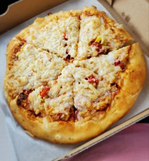 Medium vegan pizza with traditional sauce, "cheese", roasted red peppers, banana peppers, & onions at Guiseppe's in Akron