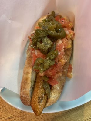 closer look of a vegan hotdog with salsa and jalapeños at Bells in Tokyo