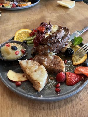 half french toast/ half pancakes with apple sauce. french toast at the back of the plate, pancakes in the front. both came with a lot of fruit.  at SOUL - Vegan Coffee Bar in Hamburg