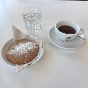 Americano and lemon chia cookie. (Location Science park).   at The Village Coffee & Music in Utrecht