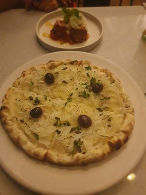 Pizza fugazzetta and albondigas  at Mudra in Buenos Aires