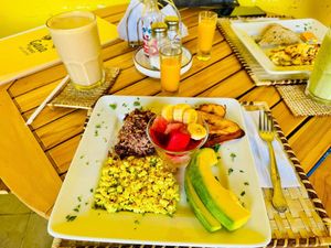 Gaia NIca Vegano, Gallopinto con tofu revuelto y ensalada de fruta, con un batido de mantequilla de mani elavorado con leche de almendra cacera  at Gaia Forest Cafe & Market in Granada