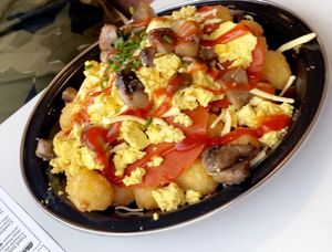 Big bowl of breakfast goodness tata tots,cheese mushrooms beans vegan bacon, scrambled tofu soooo good aand so filling Highly recommend!! at Feed Me Fully Loaded in Nottingham