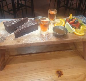 Afternoon tea: Fruit Pot. CLEMENTINE BROWNIE (ve) with chocolate sauce.

Served with 2 shots. at Revolution in Wilmslow